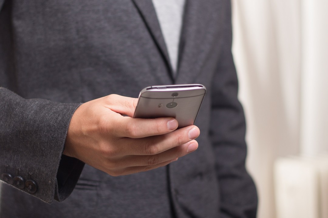 Image of man holding cell phone